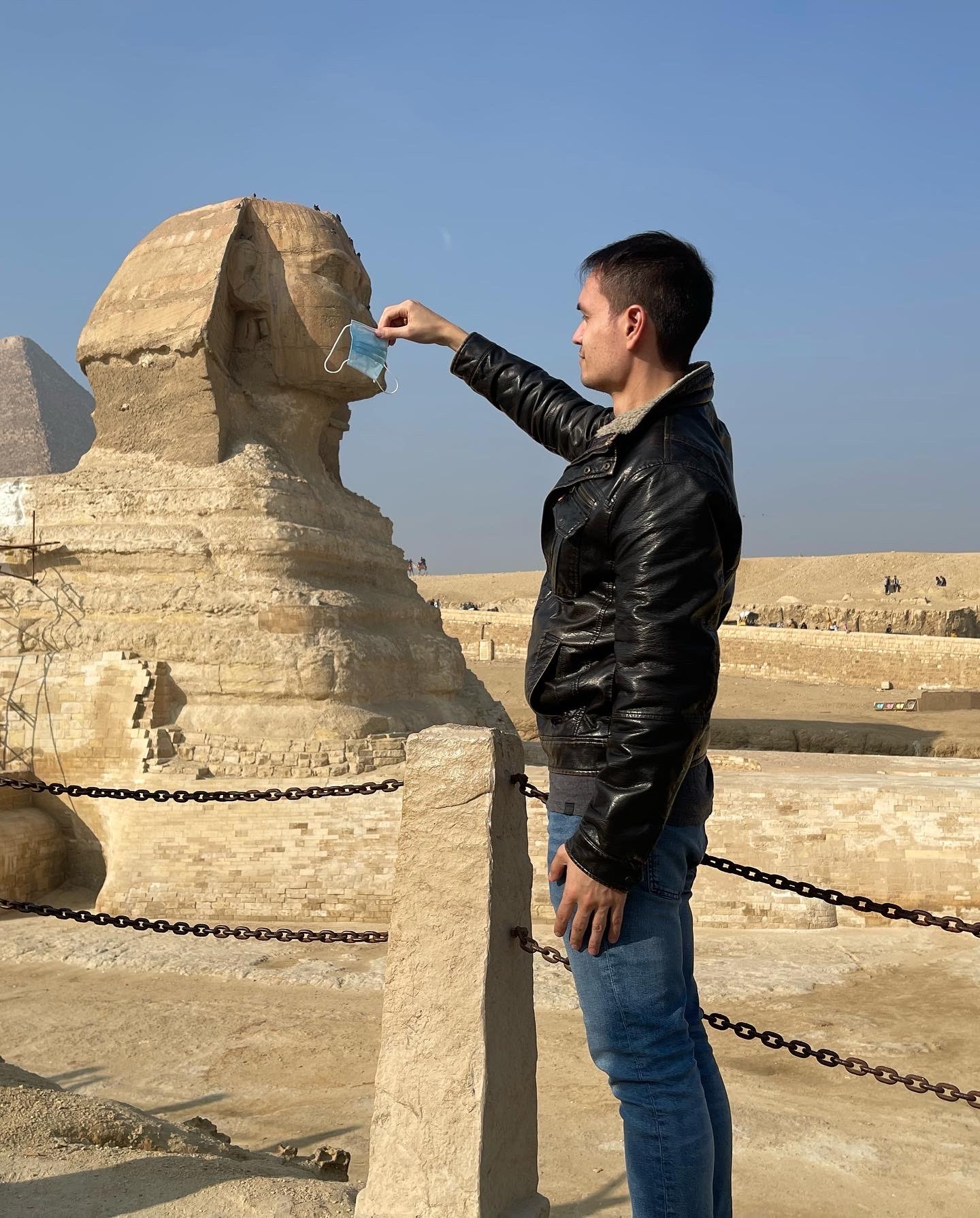 alt="putting a mask on the sphinx in Giza Egypt during the pandemic"